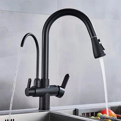 3 way stainless steel kitchen mixer tap with water flowing out of filtered water spout.