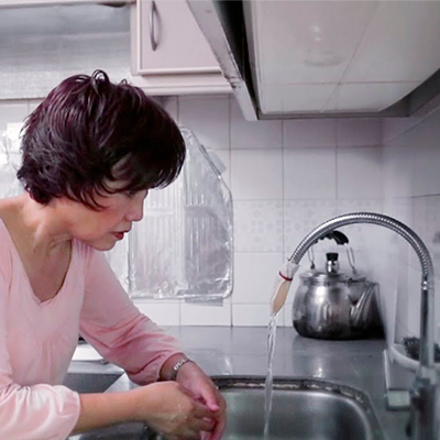 Water flowing out of tap with cloth filter.